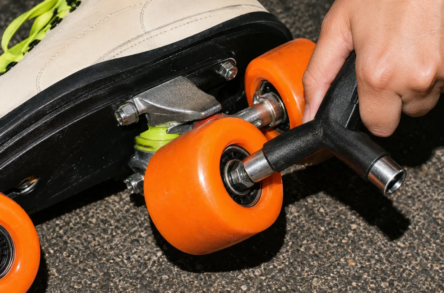 A skate tool tightening an axle nut on an upturned quad skate
